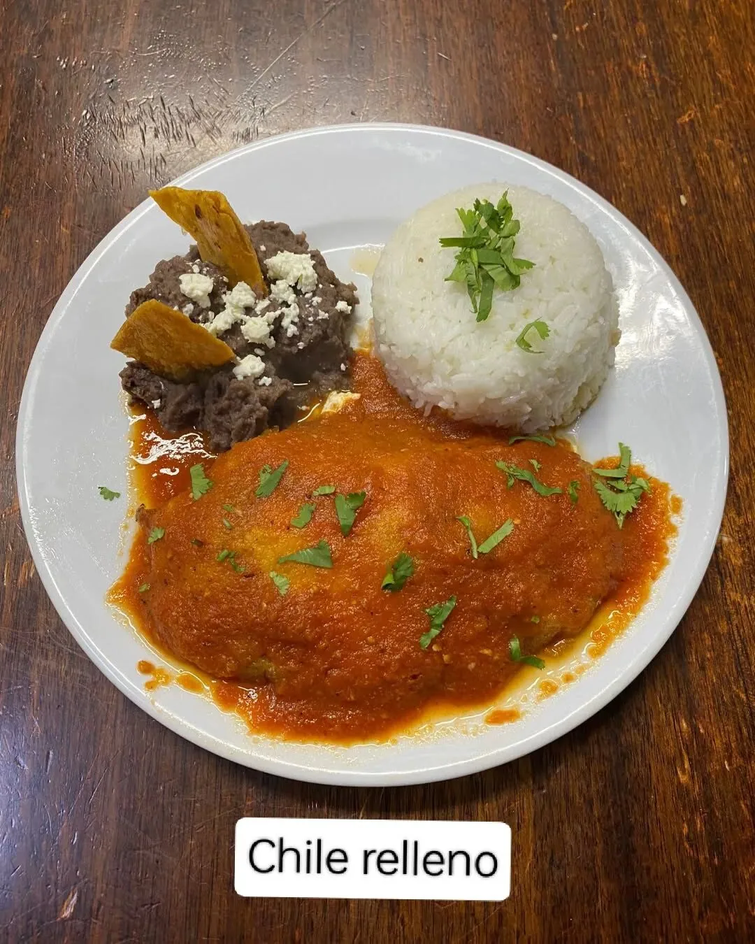 Chile relleno with rice and refried beans