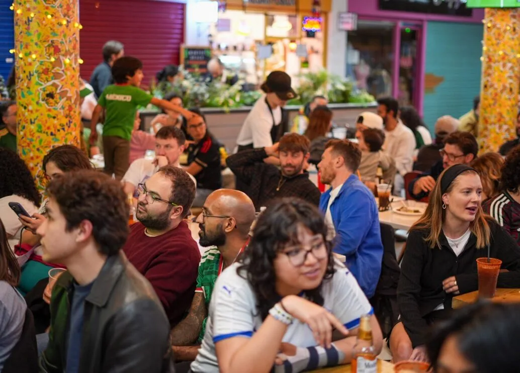 Crowds watching the football over dinner in the market food hall