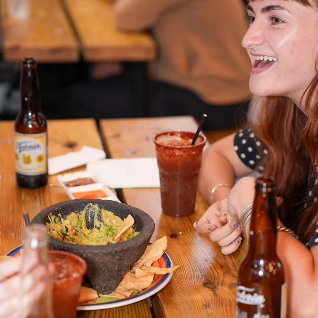 Guacamole served in a stone molcajete with tortilla chips
