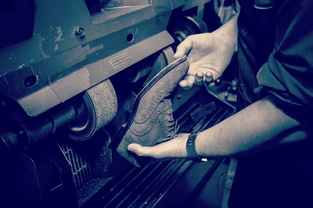 Shoes being repaired on a finishing machine at Rye Lane Shoe Care