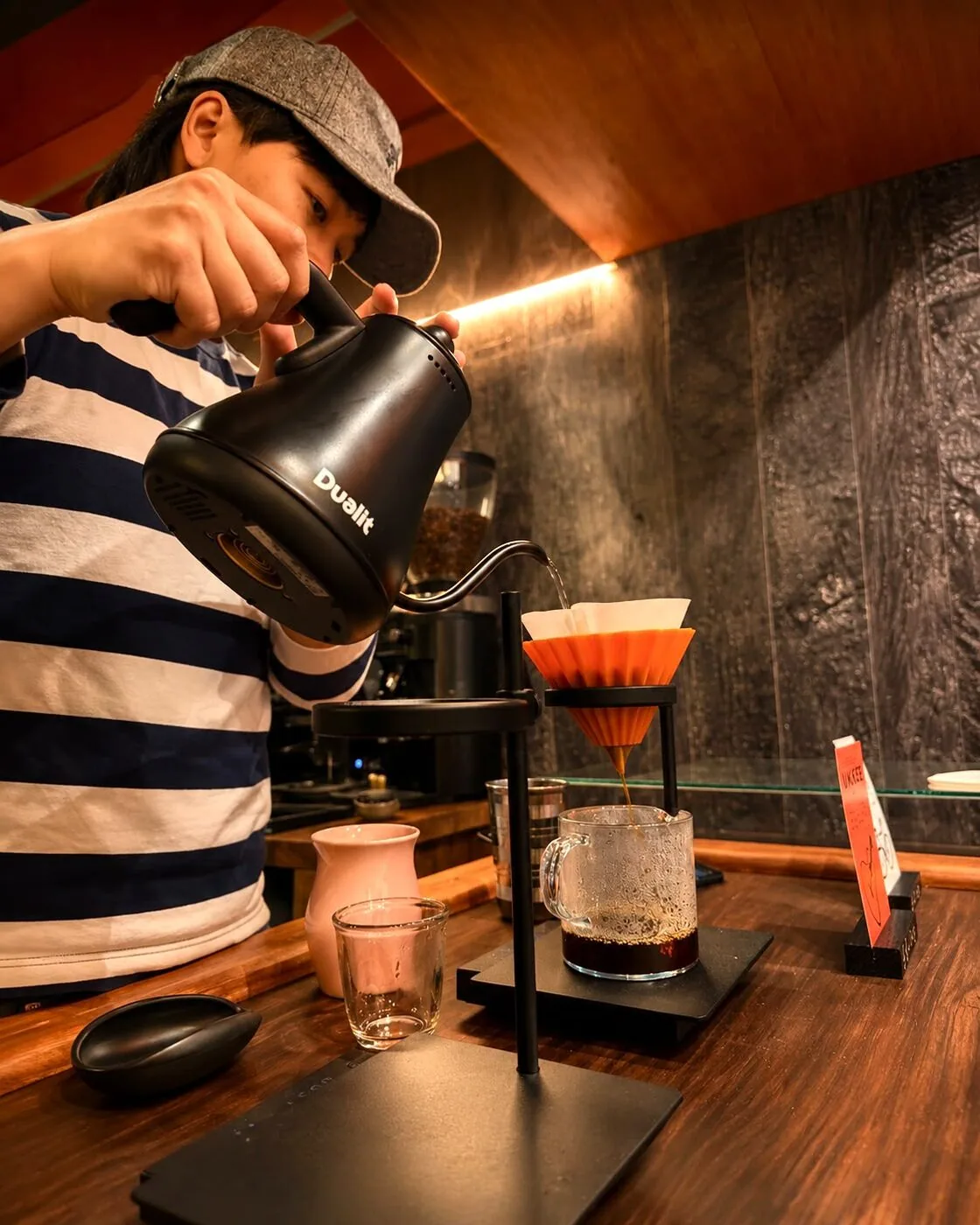 The barista at Ukkei Coffee pouring a careful pour-over