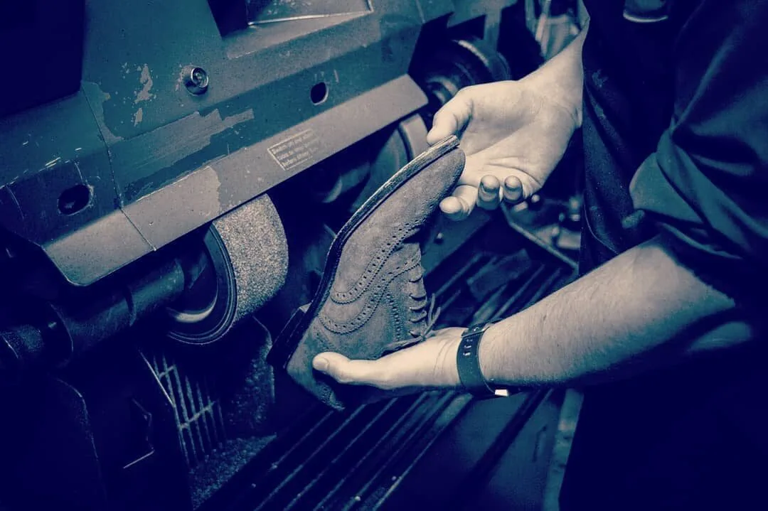 Shoes being restored on the finishing machine at Rye Lane Shoe Care